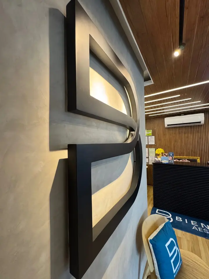 Illuminated BienPoMD logo wall near the clinic reception